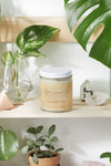 Silky organic magnesium lotion in a glass jar with a metal lid, infused with lavender and shea for soothing hydration.