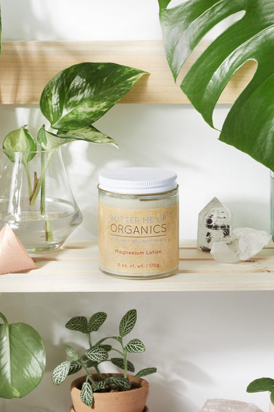 Silky organic magnesium lotion in a glass jar with a metal lid, infused with lavender and shea for soothing hydration.