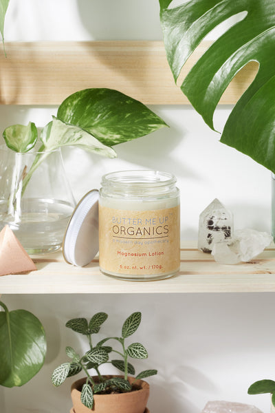 Silky organic magnesium lotion in a glass jar with a metal lid, infused with lavender and shea for soothing hydration.