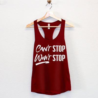 Stylish women's racerback tank top with 'Can't Stop Won't Stop' text, available in bold colors like black and red.