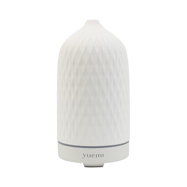 Elegant Yuemi Zen Breeze ceramic diffuser with a diamond-patterned stone design, emitting a serene essential oil mist.